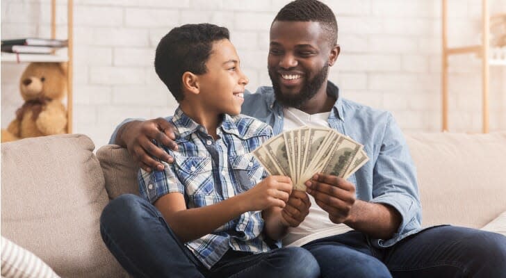 Black father and his son discussing money