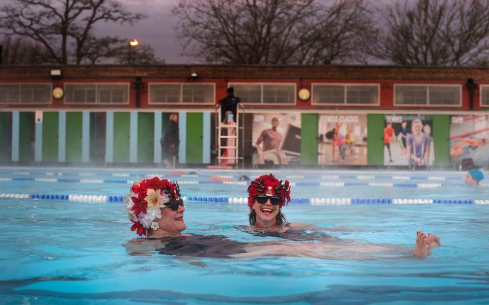 Nicola Foster and Jessica Walker, known as the Lido Ladies, swim at Charlton Lido in Hornfair Park, London - PA