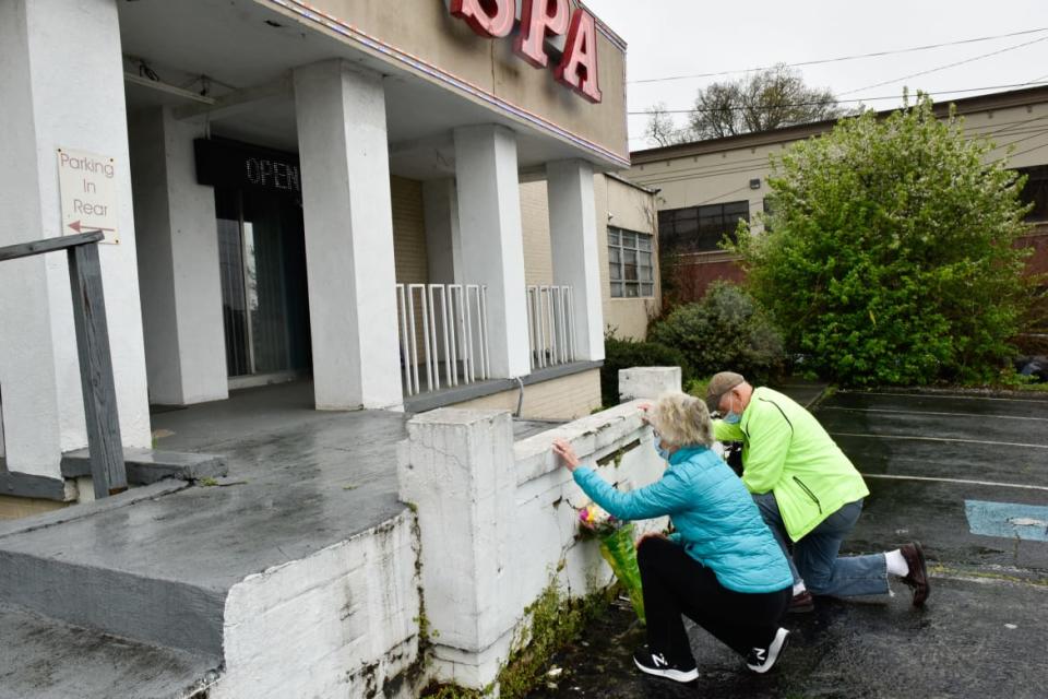 <div class="inline-image__caption"><p>John and Barbara Hayes, of Sandy Springs, Georgia, bring flowers and offer prayers at the steps of Gold Spa.</p></div> <div class="inline-image__credit">Virginie Kippelen/AFP via Getty</div>