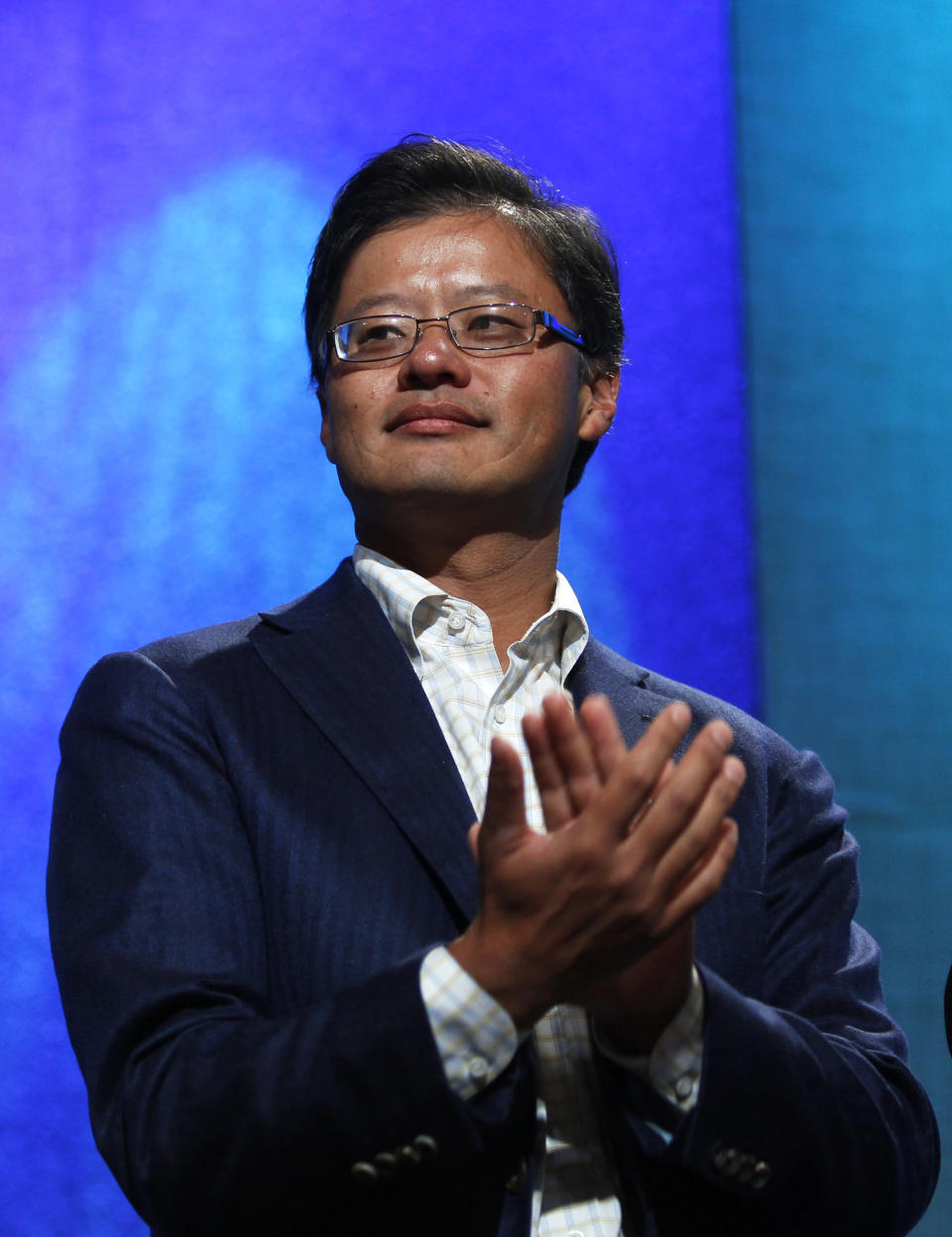 Co-founder and former CEO of Yahoo! Inc. Jerry Yang applauds during the announcement of a commitment pledge at the Clinton Gala Awards