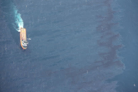 A Chinese rescue ship works to clean oil slicks from the sunken Iranian oil tanker Sanchi in the East China Sea, in this January 15, 2018 handout picture released by China's Ministry of Transport January 17, 2018. China's Ministry of Transport/Handout via REUTERS