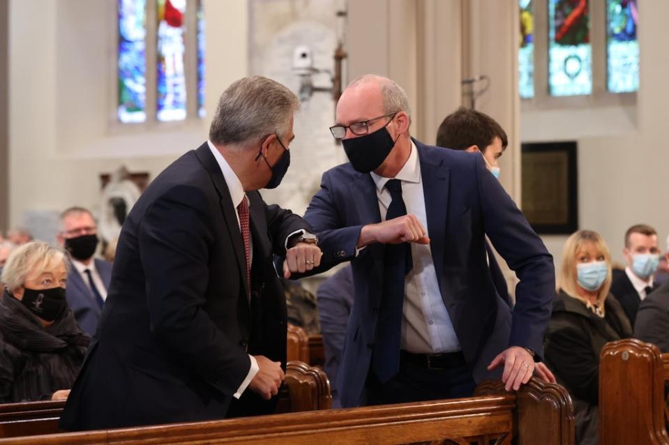 Brandon Lewis (left) and Simon Coveney bump elbows in greeting at the service to mark Northern Ireland’s centenary (Liam McBurney/PA) (PA Wire)