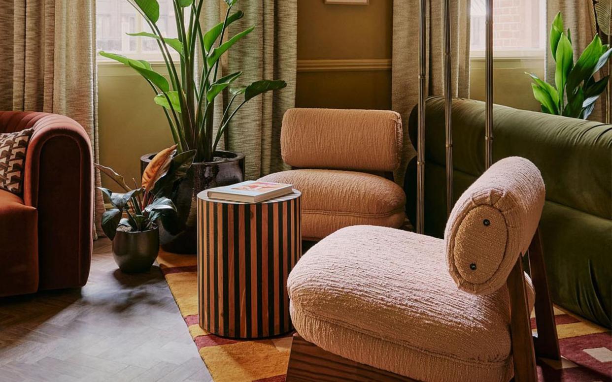  A reading corner with books, chairs and plants. 