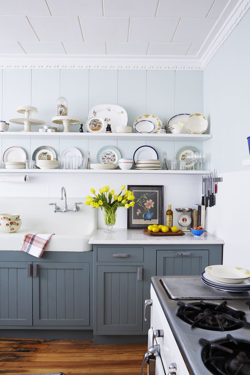 farmhouse kitchen with dark gray blue color on cabinets and pale blue color on walls