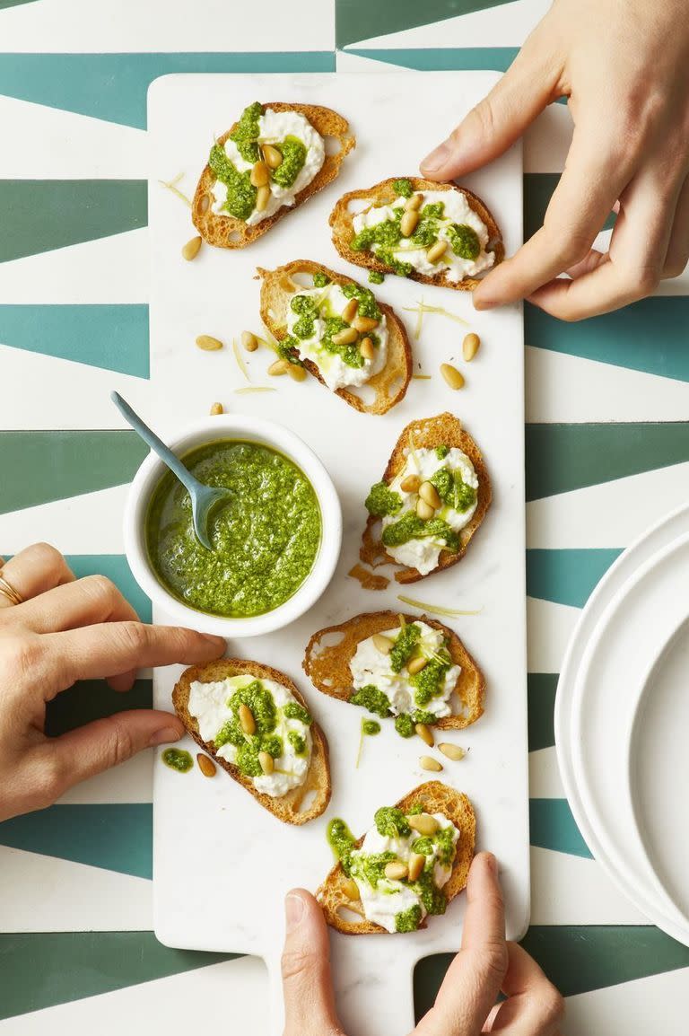 <p>Sneak arugula into this pesto for added nutrients and color. Drizzle it over a slice of fresh bread or in this case, on top of ricotta-coated crostini.</p><p><a href="https://www.goodhousekeeping.com/food-recipes/easy/a19865763/arugula-pesto-recipe/" rel="nofollow noopener" target="_blank" data-ylk="slk:Get the recipe »" class="link rapid-noclick-resp"><em>Get the recipe »</em></a><br></p>