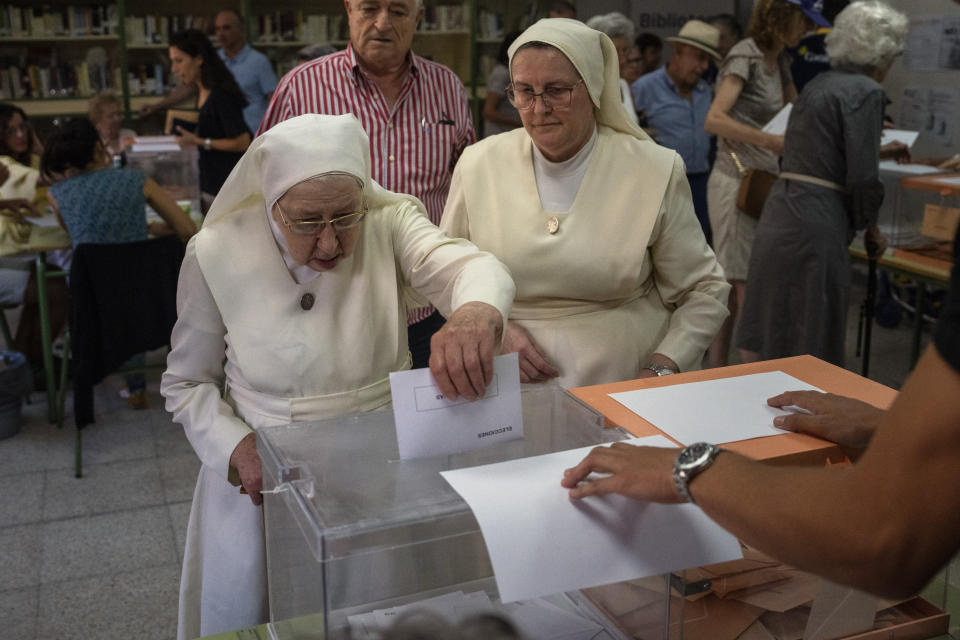 Nuns cast their ballots before voting at a polling station for Spain's general election, in Madrid, Sunday, July 23, 2023. Sunday's election could make the country the latest European Union member to swing to the populist right, a shift that would represent a major upheaval after five years under a left-wing government. (AP Photo/Emilio Morenatti)