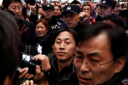 North Korean national Ri Jong Chol (C) is surrounded by media after his arrival at Beijing airport, China, March 4, 2017. REUTERS/Thomas Peter