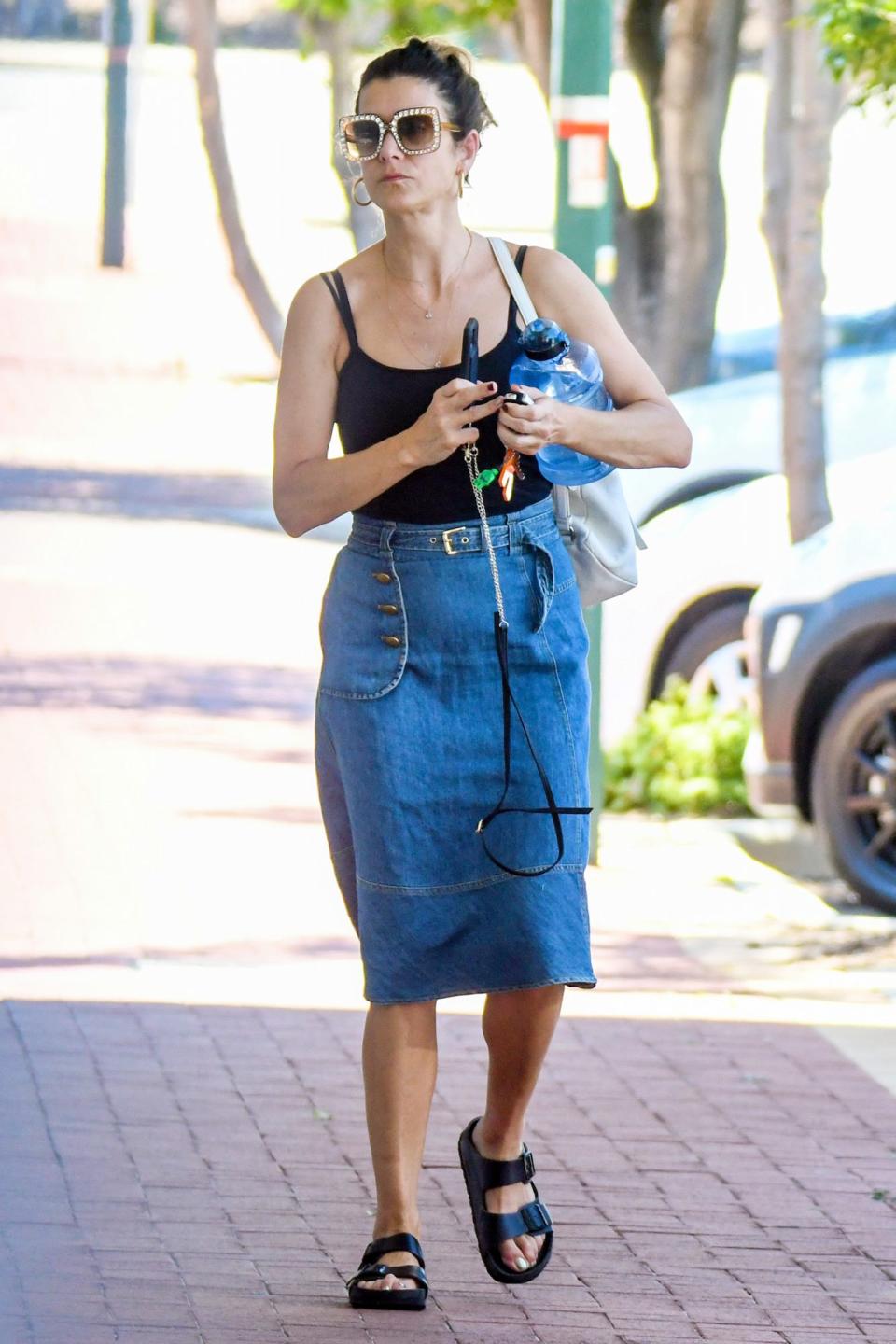 <p>Kate Walsh steps out in rhinestone-edged sunglasses for an afternoon walk in Perth, Australia on Sunday.</p>