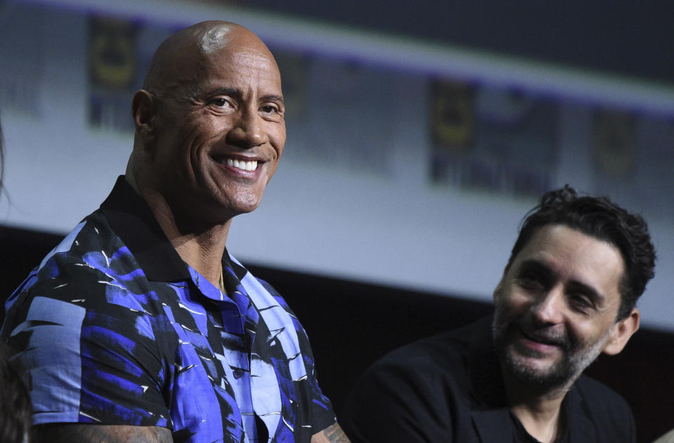 Dwayne Johnson, left, also known as The Rock, and Jaume Collet-Serra participate in the "Black Adam" portion of the Warner Bros. Theatrical panel on day three of Comic-Con International on Saturday, July 23, 2022, in San Diego. (Photo by Richard Shotwell/Invision/AP)