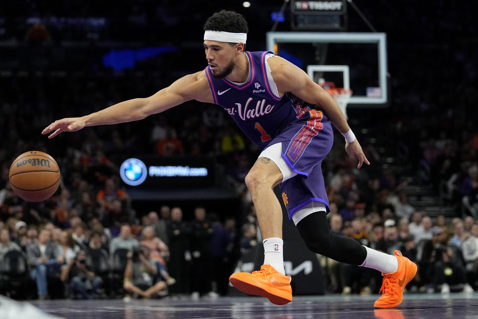 Phoenix Suns guard Devin Booker chases down a loose ball during the second half of an NBA In-Season Tournament basketball game against the Portland Trail Blazers, Tuesday, Nov. 21, 2023, in Phoenix. (AP Photo/Matt York)