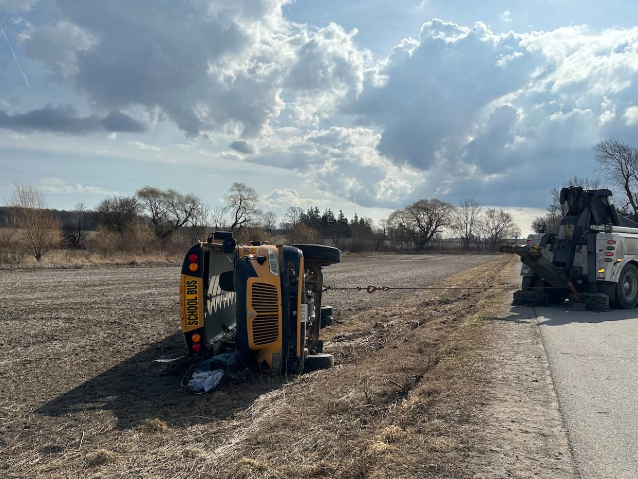 Forty children were on the school bus when it rolled over in a single vehicle crash. Paramedics said all of the injuries were minor with one student being airlifted to a London hospital.  (Kate Dubinski/ CBC News - image credit)