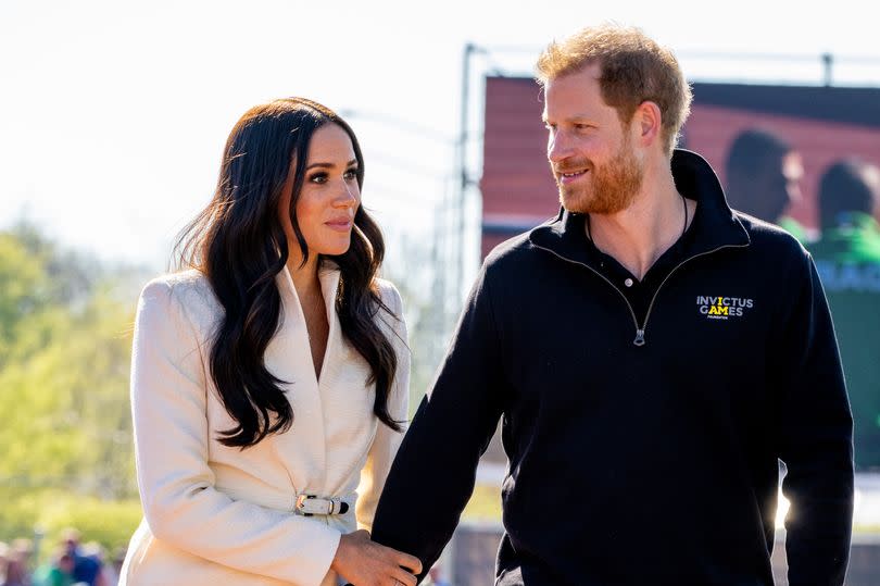 Meghan Markle and Prince Harry holding hands