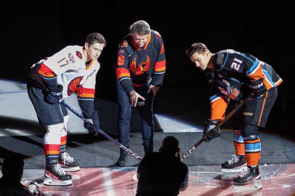 Coachella Valley forward Max McCormick (left) and San Diego Gulls center Glenn Gawdin (right) pose with NHL legend Wayne Gretzky for the ceremonial puck drop on Sunday, Jan. 22, 2023 at Acrisure Arena.