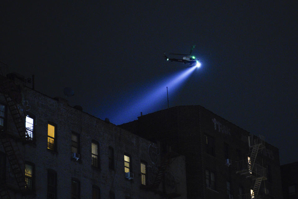 A New York City Police Department helicopter patrols the area after a shooting at the Mount Eden Avenue subway station, Monday, Feb. 12, 2024, in the Bronx borough of New York. (AP Photo/Eduardo Munoz Alvarez)