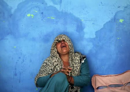 The mother of an Indian policeman who was killed in an attack on a police camp, weeps at her residence in Kathua district, south of Jammu March 20, 2015. REUTERS/Mukesh Gupta