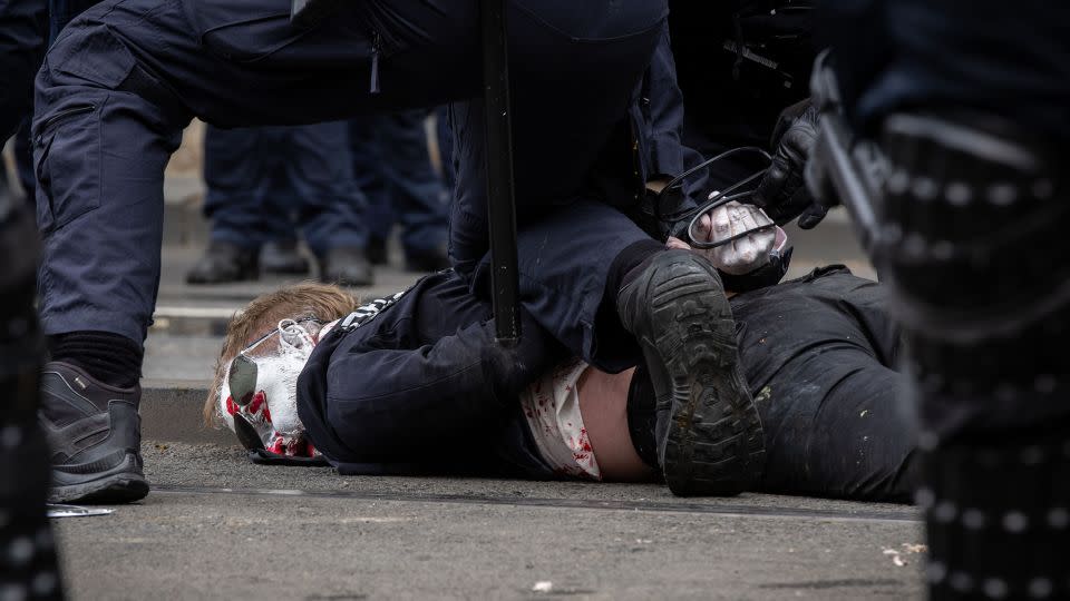 A protester is detained by Victoria Police on Spencer Street on September 11, 2024 in Melbourne. - Darrian Traynor/Getty Images