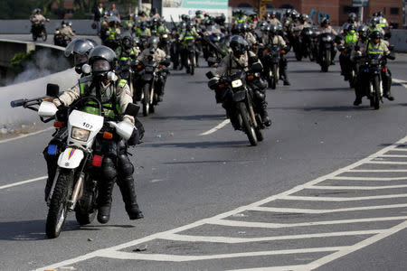 Riot police fire tear gas toward opposition supporters during clashes while rallying against Venezuela's President Nicolas Maduro in Caracas, Venezuela April 24, 2017. REUTERS/Marco Bello