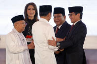 Indonesian President Joko Widodo, second left, and his running mate Ma'ruf Amin, left, and his contender Prabowo Subianto, second right, with his running mate Sandiaga Uno, right, shake hands after a televised debate in Jakarta, Indonesia, Thursday, Jan. 17, 2019. Indonesia is gearing up to hold its presidential election on April 17 that will pit in the incumbent against the former general.(AP Photo /Tatan Syuflana)