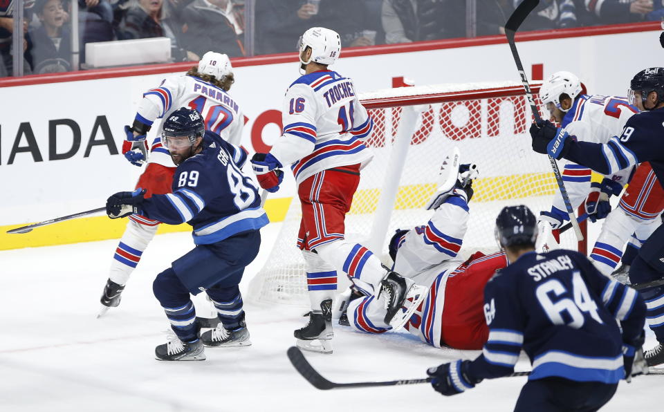 Winnipeg Jets' Sam Gagner (89) begins to celebrate after scoring against New York Rangers goaltender Jaroslav Halak during the third period of an NHL hockey game Friday, Oct. 14, 2022, in Winnipeg, Manitoba. (John Woods/The Canadian Press via AP)