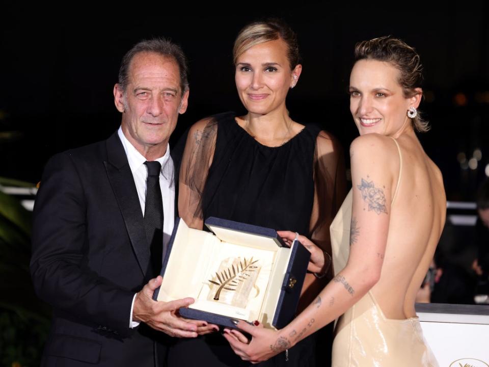 Vincent Lindon, Julia Ducournau and Agathe Rousselle pictured with the prestigious Palme d’Or prize at Cannes Film Festival 2021 (Getty Images)