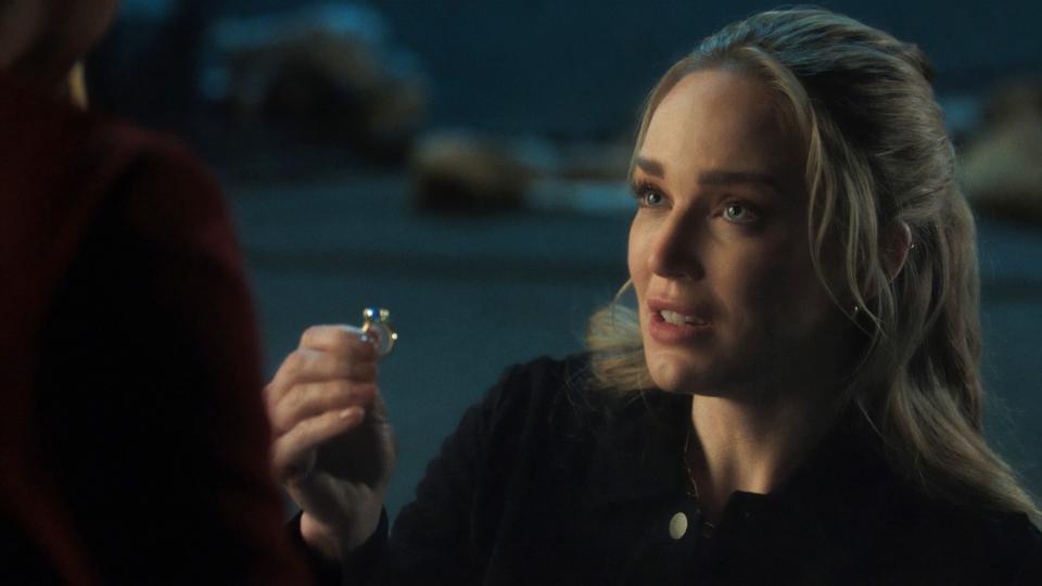 Caity Lotz as Sara Lance on one knee, holding a ring, proposing in a scene from a TV show