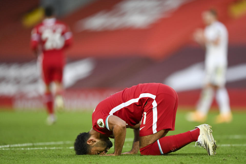 Liverpool's Mohamed Salah, left, celebrates after he scored his side's fourth goal during the English Premier League soccer match between Liverpool and Leeds United, at the Anfield stadium, in Liverpool, Saturday, Sept. 12, 2020. (Shaun Botterill, Pool via AP)