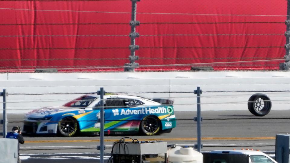 Ross Chastain (1) avoids a tire that fell off the Kaz Grala car during the NASCAR Daytona 500 auto race Sunday, Feb. 20, 2022, at Daytona International Speedway in Daytona Beach, Fla. (AP Photo/Chris O'Meara)