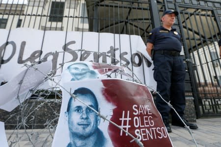 FILE PHOTO: Barbed wire and placards with images of Ukrainian film director Sentsov are seen after a rally in Kiev