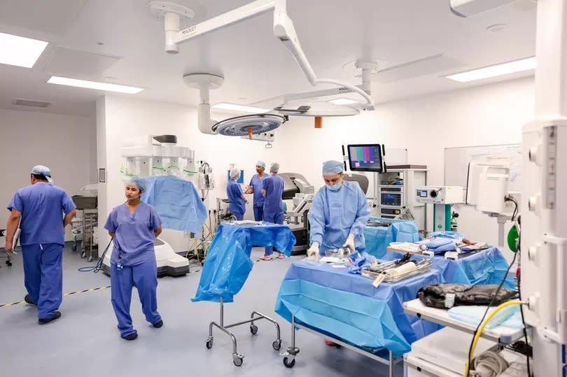 The team at The Christie prepares to perform an operation using a robot -Credit:Kenny Brown | Manchester Evening News