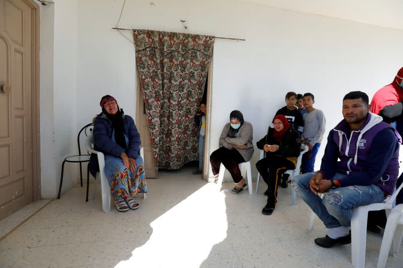 The family of Brahim Aouissaoui, suspected of Thursday's attack in Nice, France, sit in their home in Thina, a suburb of Sfax, Tunisia