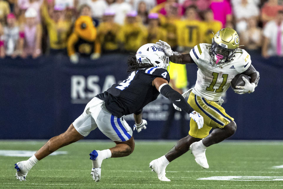 Georgia Tech running back Jamal Haynes (11) stiff arms Duke linebacker Cameron Bergeron (4) during an NCAA college football game, Saturday, Oct. 5, 2024, in Atlanta. (AP Photo/Jason Allen)