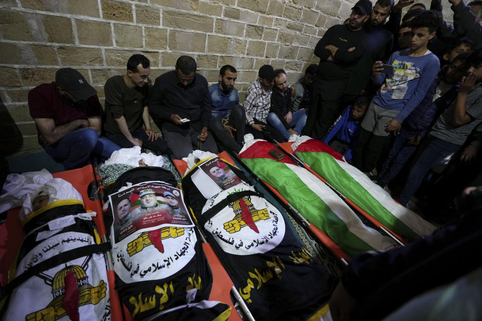 Mourners gather around bodies of Palestinians who were killed in Israeli airstrikes, during their funeral at the Omari mosque in Gaza City, Tuesday, May 9, 2023. The airstrikes killed three senior commanders of the militant Islamic Jihad group and 10 other people, including two of the commanders' wives, several of their children and others nearby. (AP Photo/Adel Hana)