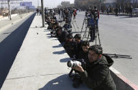 <p>Afghan journalists take photographs at the site of a deadly attack on the Intercontinental Hotel after an attack in Kabul, Afghanistan, Sunday, Jan. 21, 2018. Gunmen stormed the hotel and set off a 12-hour gun battle with security forces that continued into Sunday morning, as frantic guests tried to escape from fourth and fifth-floor windows. (Photo: Rahmat Gul/AP) </p>