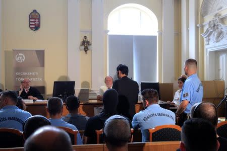 A defendant speaks, during the trial in which four men are charged with causing the death of 71 migrants who suffocated in a lorry found beside an Austrian motorway in 2015, in Kecskemet, Hungary June 21, 2017.REUTERS/Bernadett Szabo