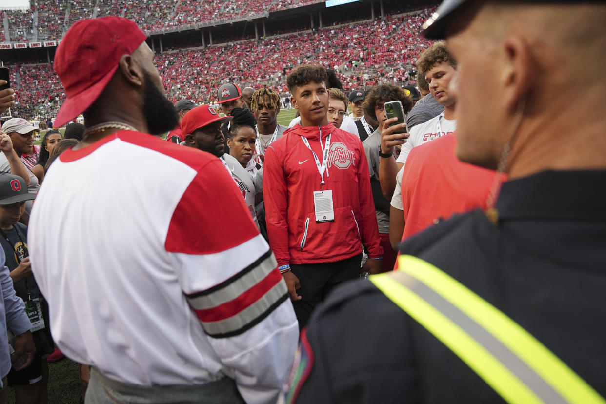 Sep 3, 2022; Columbus, Ohio, USA;  LeBron James talks to recruits including quarterback Dylan Raiola prior to the NCAA football game between the Ohio State Buckeyes and Notre Dame Fighting Irish at Ohio Stadium. Mandatory Credit: Adam Cairns-USA TODAY Sports