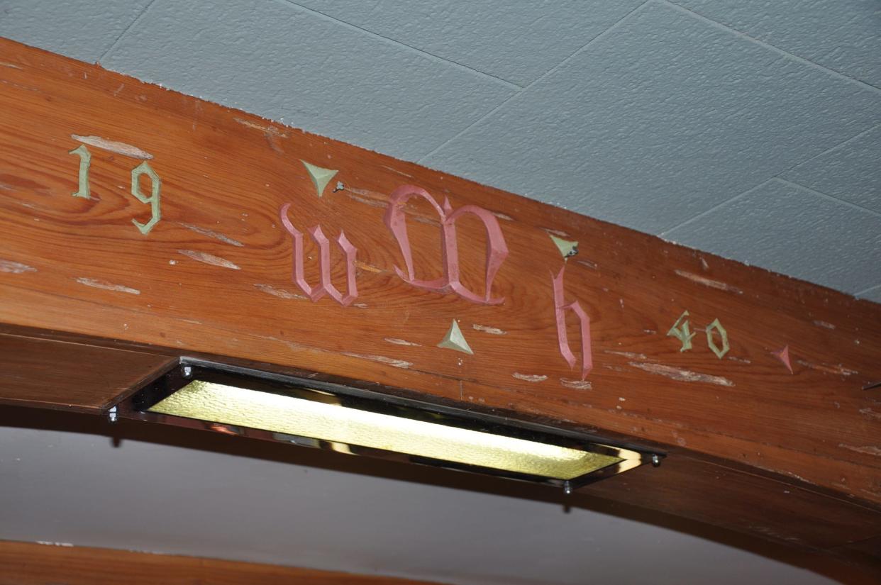 The initials of William H. Morgan Jr., the original owner of the Alliance mansion, are etched into the wood above the wet bar in the home.