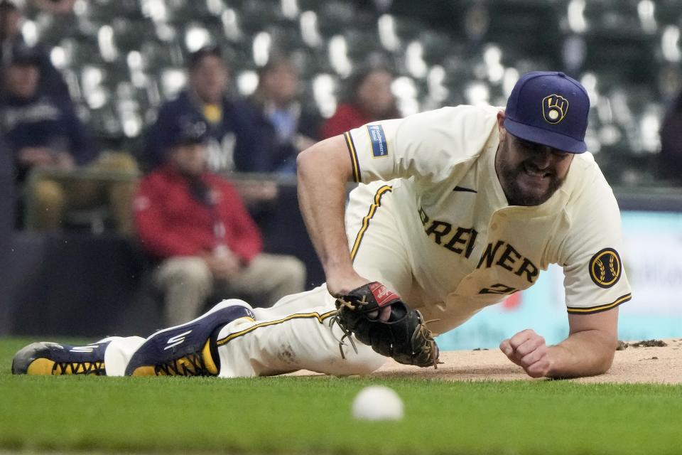 Milwaukee Brewers pitcher Wade Miley reacts after being hit in the leg by a ball hit by San Diego Padres' Manny Machado during the first inning of a baseball game Tuesday, April 16, 2024, in Milwaukee. (AP Photo/Morry Gash)