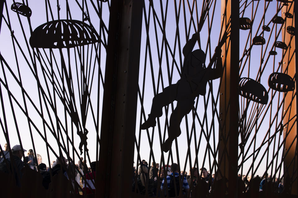 Spectators gather at the Dropzone Y monument prior to a mass parachute drop at Ginkel Heath, eastern Netherlands, Saturday, Sept. 21, 2019, as part of commemorations marking the 75th anniversary of Operation Market Garden, an ultimately unsuccessful airborne and land offensive that Allied leaders hoped would bring a swift end to World War II by capturing key Dutch bridges and opening a path to Berlin. (AP Photo/Peter Dejong)