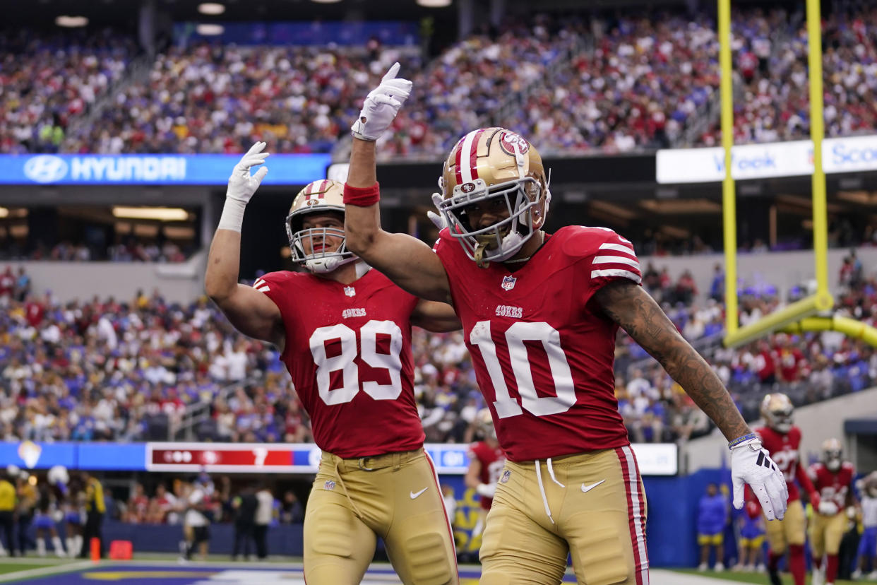 San Francisco 49ers tight end Charlie Woerner, left, and wide receiver Ronnie Bell celebrate a touchdown by running back Christian McCaffrey during the first half of an NFL football game Sunday, Sept. 17, 2023, in Inglewood, Calif. (AP Photo/Ashley Landis)
