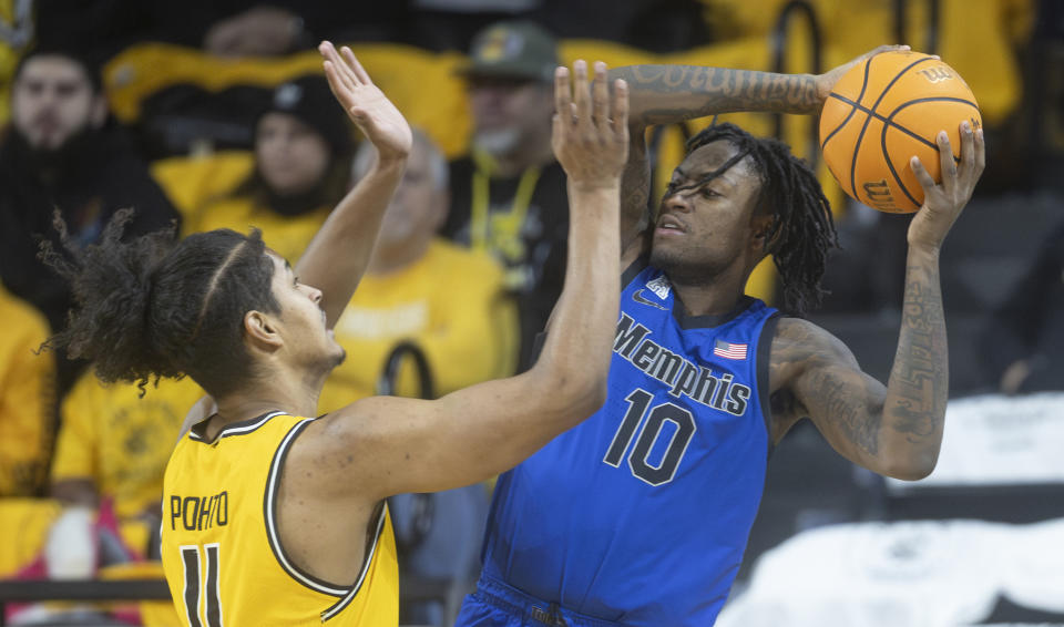 Memphis' Jaykwon Walton looks for a pass against Wichita State defender Kenny Pohto during the first half of an NCAA college basketball game, Sunday, Jan. 14, 2024, in Wichita, Kan. (Travis Heying/The Wichita Eagle via AP)