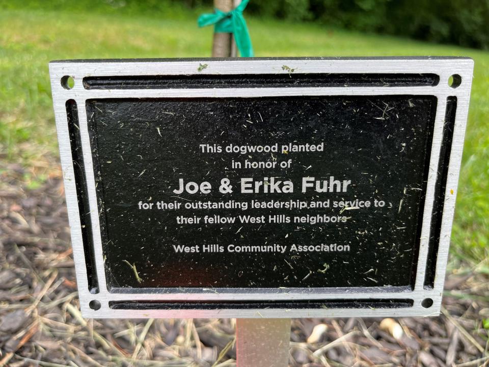 A plaque to West Hills neighborhood volunteers is shown next to a newly planted dogwood tree in West Hills Park. Five trees were recently planted there and dedicated to longtime community leaders.