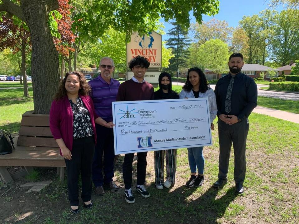 Students with Vincent Massey Secondary School's Muslim Students Association presented a cheque for $5,500 to the Downtown Mission on Tuesday. The students raised the funds during Ramadan. (Darrin Di Carlo/CBC - image credit)