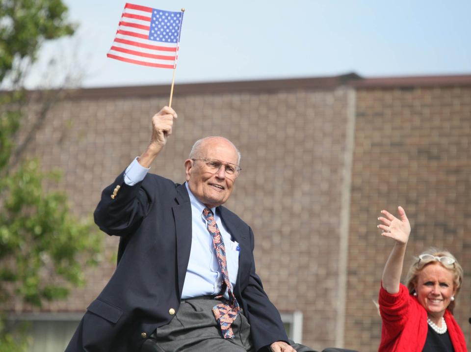 John Dingell smiles with his wife while riding in the Memorial Day parade in Dearborn, Monday May 27, 2013.