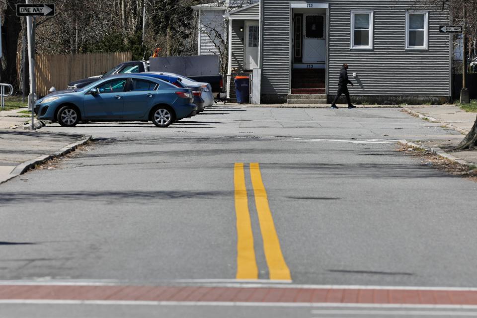 A man walks up Purchase Street in New Bedford past Griffin Court which will be renamed to honor iconic music group Tavares.