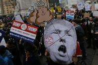 People take part in a protest against Republican presidential candidate Donald Trump, on March 19, 2016 in New York