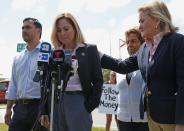 Rep. Sylvia Garcia, D-Texas, right, comforts Rep. Debbie Mucarsel-Powell, D-Fla., center, as she talks about their tour of the Homestead Temporary Shelter for Unaccompanied Children, Tuesday, Feb. 19, 2019, in Homestead, Fla. Rep. Joaquin Castro, D-Texas, left, chairman of the Congressional Hispanic Caucus, and Rep. Donna Shalala, D-Fla., look on. (AP Photo/Wilfredo Lee)