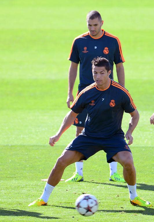 Real Madrid's Karim Benzema (back) and Cristiano Ronaldo take part in a training session in Madrid on October 1, 2013