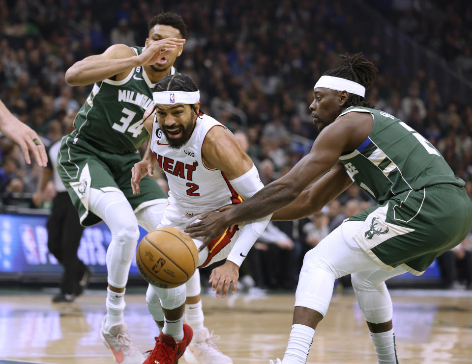Miami Heat guard Gabe Vincent (2) drives against Milwaukee Bucks' Jrue Holiday, right, during the first half of Game 5 in a first-round NBA basketball playoff series Wednesday, April 26, 2023, in Milwaukee. (AP Photo/Jeffrey Phelps)
