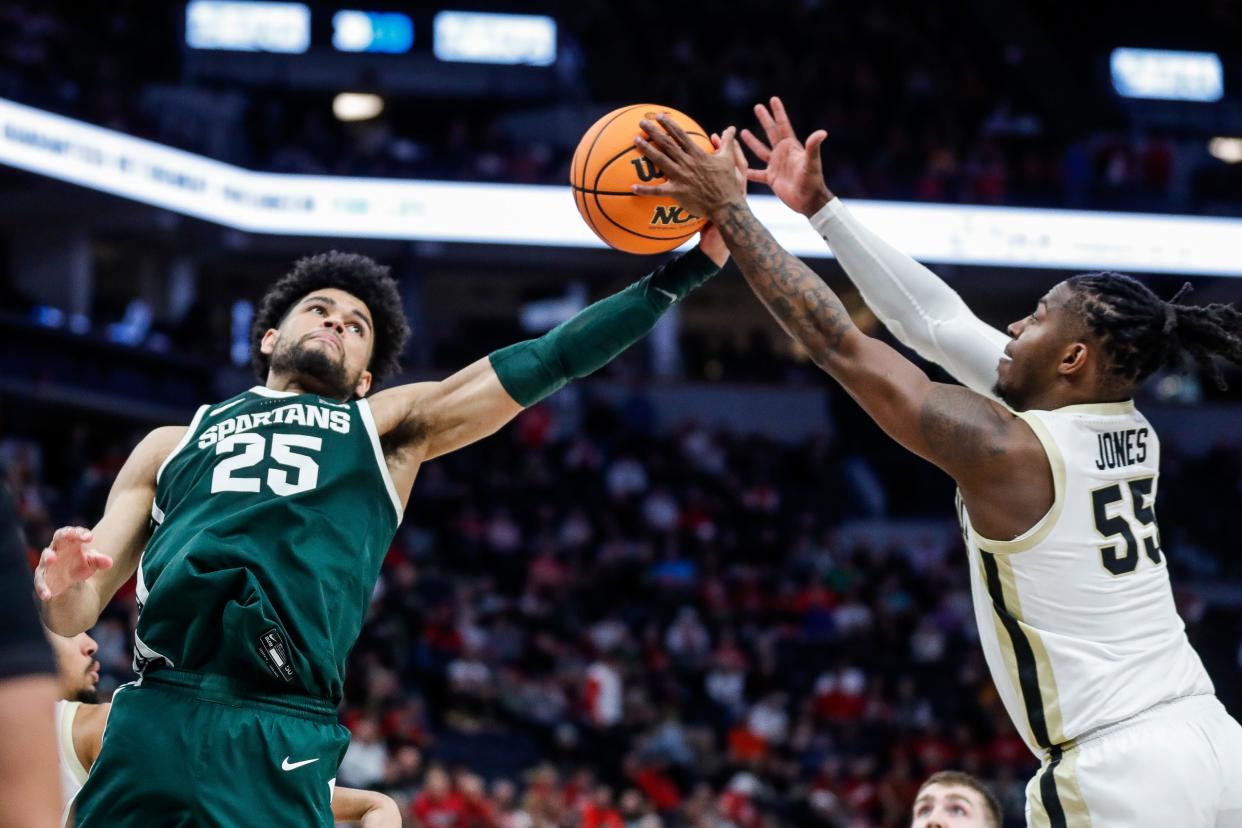 Michigan State forward Malik Hall (25) and Purdue guard Lance Jones (55) battle for a rebound during a quarterfinal of Big Ten tournament. Both played part of their high school ball in Illinois.