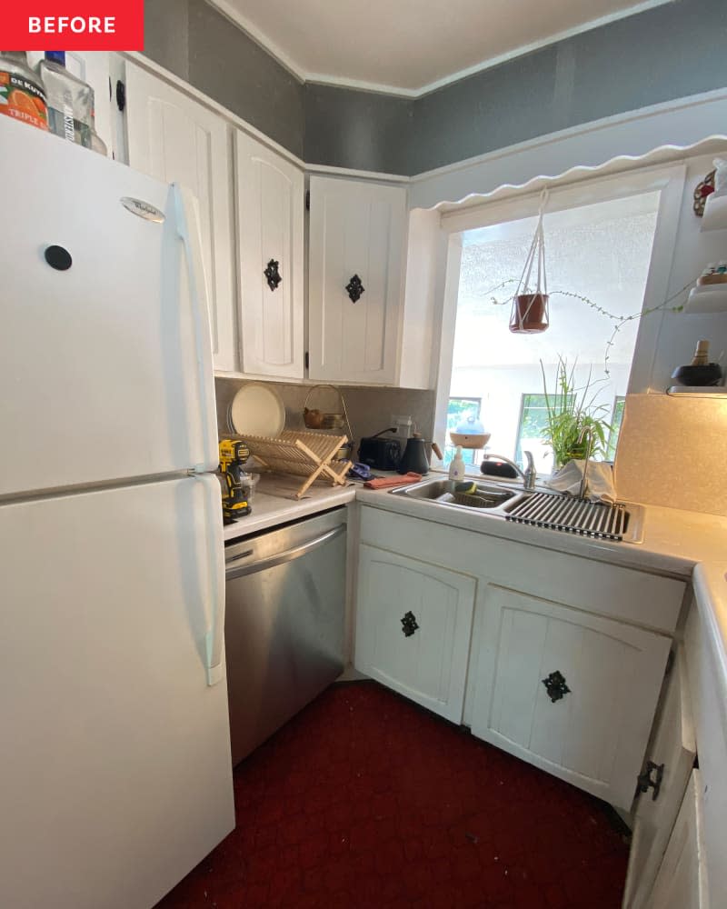 white kitchen with white cabinets and red carpeting before remodel